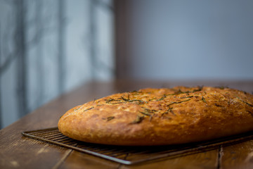 freshly baked italian focaccia bread on wooden table