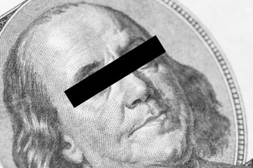 Benjamin Franklin portrait close-up with his eyes covered with black stripe . Concept of censorship