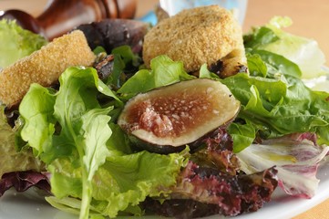 salad with crostini goat cheese, green leaves and fig