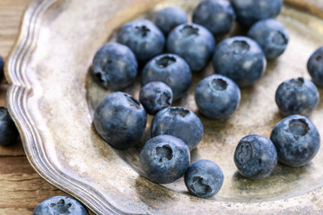 Blueberries on vintage metal plate.