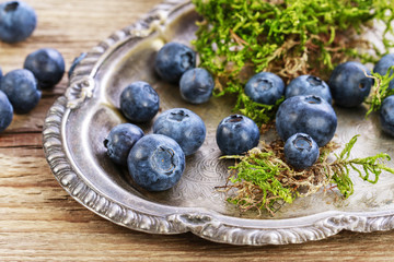 Blueberries on vintage metal plate.