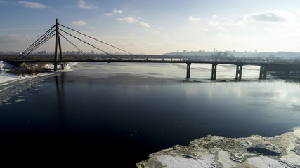 Fototapeta na wymiar Landscape with suspension Moscow Bridge across the Dnieper river, Obolon, Kiev, Ukraine