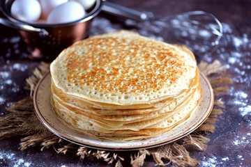 Russian traditional pancakes on milk with yeast.