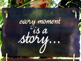 Inspirational motivation quote Every moment is a story on a sigh hanging in tree