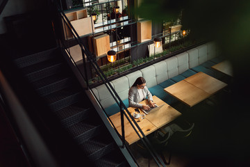 Top angle shot of an beautiful business woman working from cafe. Business, online business, working online concept.