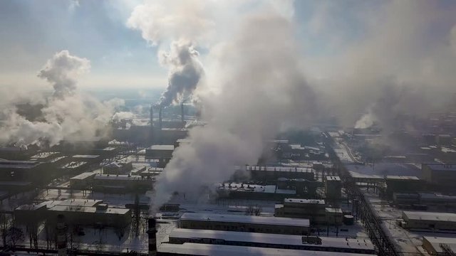 Aerial view of factory smoke stack - Oil refinery, petrochemical or chemical plant in winter