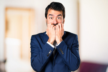 Frightened handsome man on unfocused background