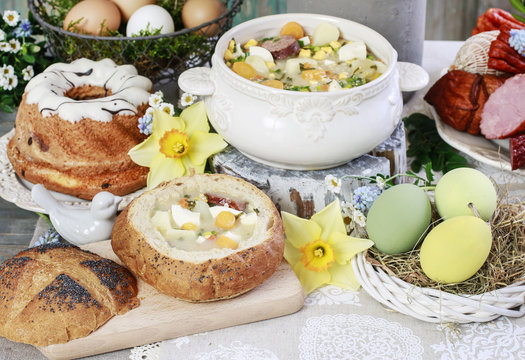 The sour rye soup, easter cakes and saussages on the table.