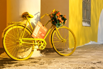 Fototapeta na wymiar Yellow bicycle with flowers.