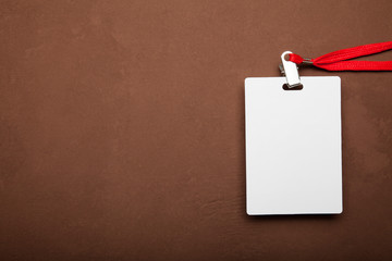 Blank badge mockup isolated on brown background.