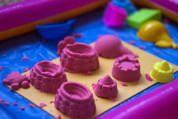 Pink kinetic sand, educational game for children. The development of motor skills in boys and girls