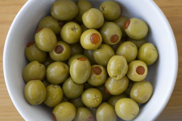 Pimento stuffed green olives in a white bowl