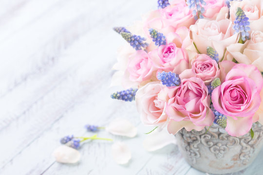 Romantic flower bouquet on light wooden background