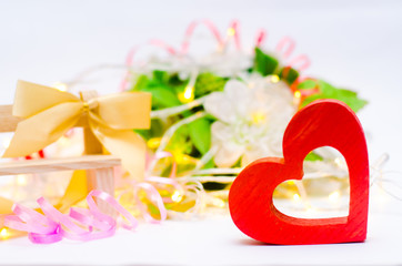 wooden heart with a bow on a bench on a white background. Valentine's Day