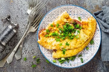 Omelet or omelette with fresh green onion, scrambled eggs - obrazy, fototapety, plakaty