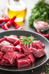 Raw beef meat sliced on black background