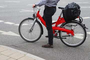 Fototapeta na wymiar Man on red bicycle in the city