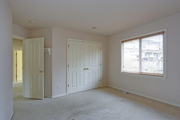 Empty bedroom with cream paint color walls