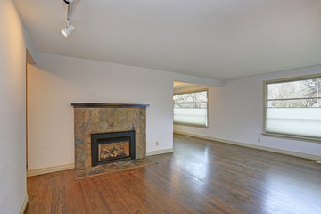 Large empty living area with hardwood floor