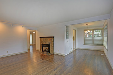 Large empty living area with hardwood floor