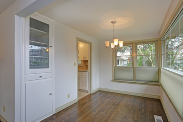 White empty dining area with hardwood floor
