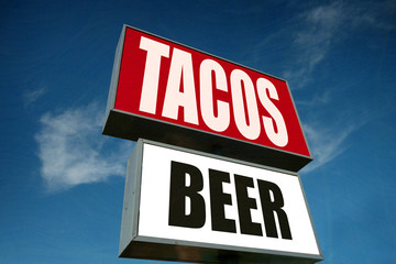 aged and worn tacos and beer sign