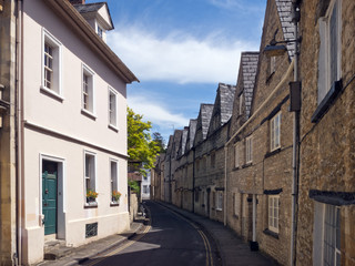 Fototapeta na wymiar Quaint and historic buildings line the streets in the older parts of Cirencester, Gloucestershire, UK