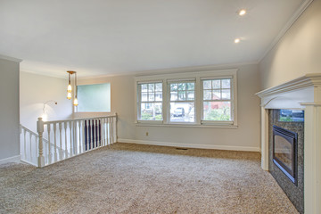 Light open living area with traditional fireplace
