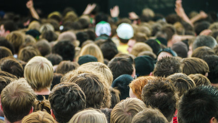 Crowd of people standing seen from behind