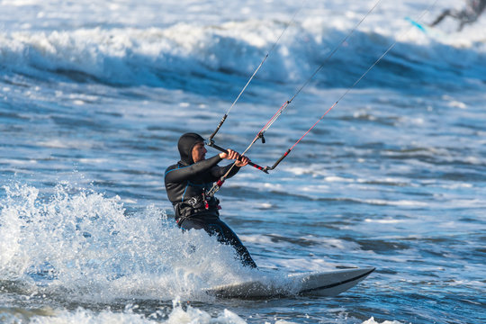 Kitesurfer riding ocean waves