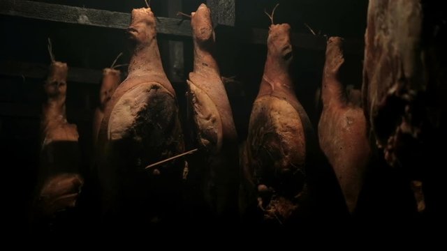 Traditional way of cooking Prosciutto. Large pieces of meat are smoked
