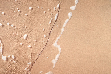 Fototapeta na wymiar wave on sandy beach
