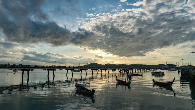 4-K time lapse of longtail fishing boats in aochalong harbor phuket thailand