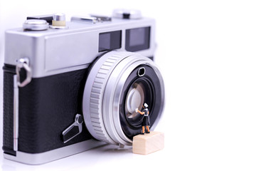 Fototapeta premium Miniature people : maid cleaning a Retro, old, vintage and classic film camera