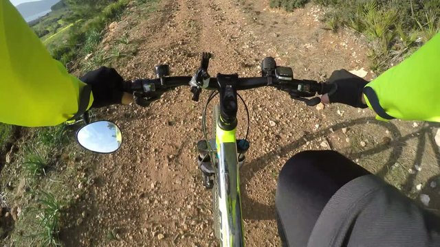 first person view of a mountain bike ride on a dirt path in Sardinia, Italy