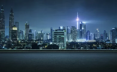 Poster Asphalt road side with beautiful Kuala Lumpur city skyline. Night scene . © jamesteohart
