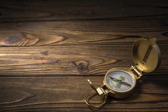 Vintage gold compass on tree background. copy space. Place for text and advertising. Idea: travel, tourism, navigation