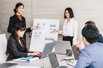 Businesspeople presenting and using laptops and discussing together in meeting room.Teamwork concept