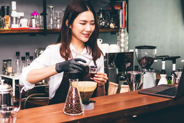 Barista holding coffee in coffee shop
