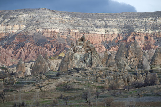 A rock with dwellings of ancient Christians on a gloomy January day. Cappadocia, Turkey