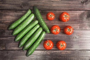 Tomatoes and cucumders on wood