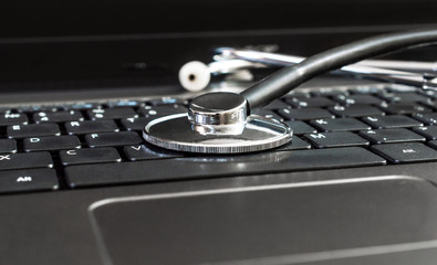 Stethoscope on laptop keyboard. Close up.