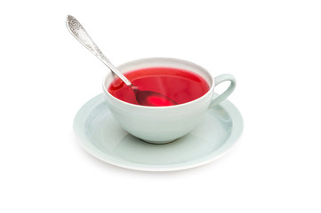 Cup of tea with tea spoon on white background.