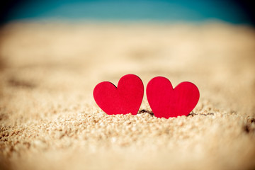 Fototapeta premium romantic symbol of two hearts on the beach 