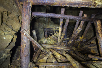 Underground abandoned gold ore mine shaft tunnel gallery collapsed wooden timbering