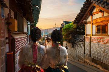 Korean lady in Hanbok and walk in an ancient town
