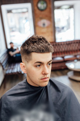 male model shows a haircut in a barber shop