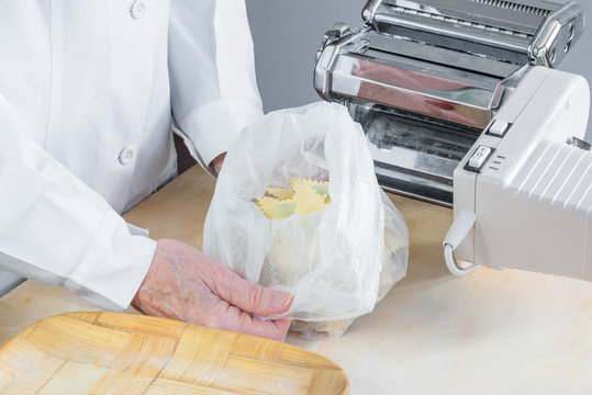 Traditional Italian pasta. Tortelli with spinach and ricotta just made and placed in a bag, after a short stay in frizer, ready to be frozen permanently and stored