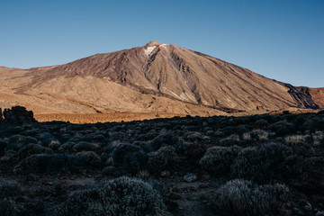 Teide Volcano with blue sky and a huge shadow on the front in the morning