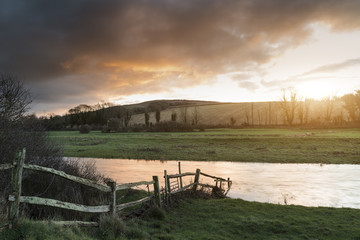 Fototapeta na wymiar Beautiful Winter sunrise landscape of Cuckmere River winding through South Downs countryside in England